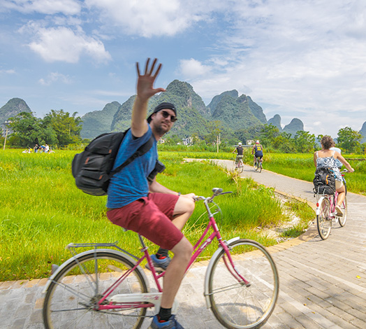 Person cycling through a scenic landscape