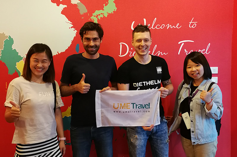 UME Travel staff posing with happy international clients