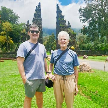 A mother and a son exploring tropical temple grounds