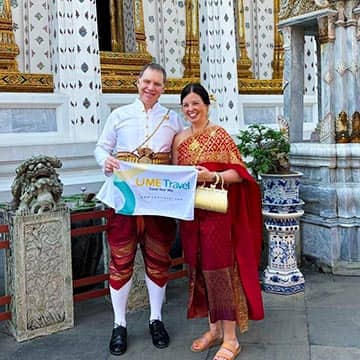 Couple wearing traditional Thai costumes at a Bangkok temple during a cultural tour