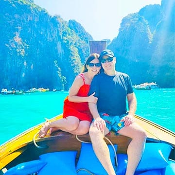 A romantic couple sailing on traditional longtail boat