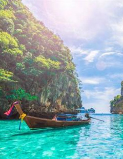 Traditional longtail boat on an emerald karst water lagoon in Phuket